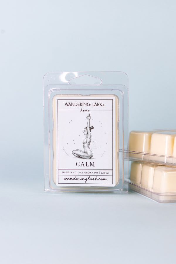 Soy Wax Melts in a clear container with a soft blue label with an illustration of a woman doing yoga.